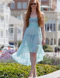 Redhead teen Bree Abernathy goes fr a walk outdoors in a see thru dress