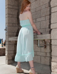 Redhead teen Bree Abernathy goes fr a walk outdoors in a see thru dress