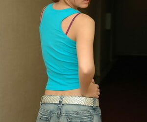 Teen solo girl strips to her brassiere in faded denim jeans