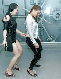 Clothed girls get caught in water sprinkler inside a submarine