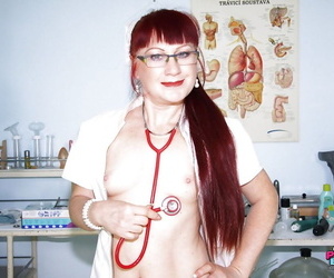 Filthy redhead mature nurse in glasses toying her hairy muff