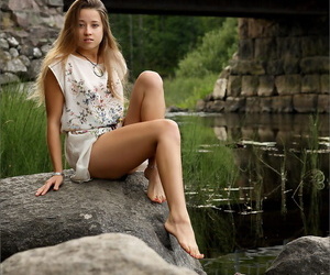 Gorgeous blonde model gets naked by the river to air her hot skinny body