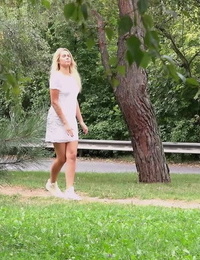 Beautiful blonde Nikki Dream in white lace dress pauses to pee in the park