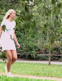 Beautiful blonde Nikki Dream in white lace dress pauses to pee in the park