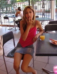 Petite teen girl poses non nude in a denim skirt at a juice bar