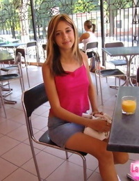 Petite teen girl poses non nude in a denim skirt at a juice bar
