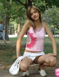 Miniature teen amateur flashes a no panty upskirt in a public park