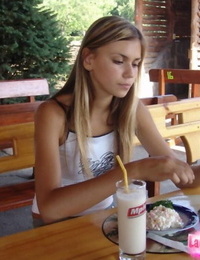 Juvenile blonde amateur flashes exposed upskirt whilst enjoying milkshake outdoors