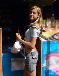 Skinny teen with long legs in short skirt looking sexy in public