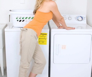 Middle-aged lady Nicole Logan reveals her clit after disrobing in laundry room