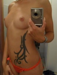 Infant with an inked body Ella Storm takes selfies at the same time as striptease in the mirror