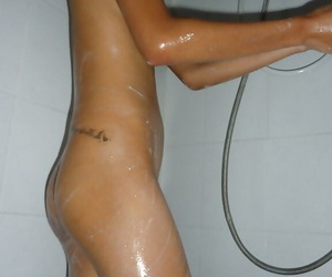 Thai teenager Dow wetting her wordy chest with an increment of penurious little irritant near shower