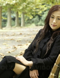 Wholly covered Japanese youthful girls in the park in brown garments and