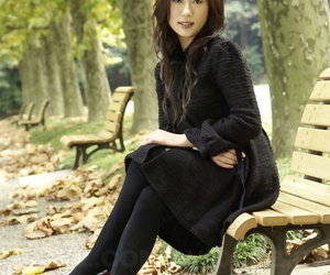 Fully clothed Japanese teen models in the park in black clothes and stockings