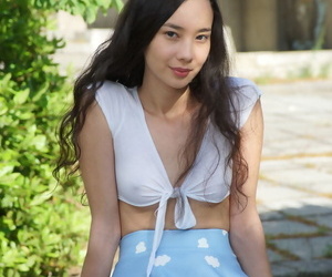 Asian teen Djessy sports a no panty upskirt before posing scanty on a patio