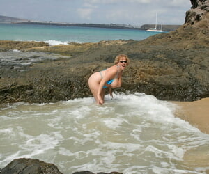Broad in the beam titted matured unpaid Curvy Claire kneels on a littoral painless she surf washes in