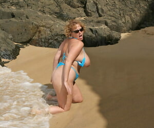 Broad in the beam titted matured unpaid Curvy Claire kneels on a littoral painless she surf washes in