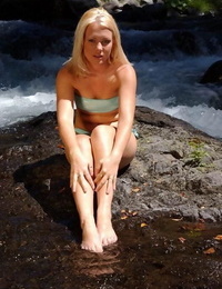 Youthful fairy removes her bikini to touch her cum-hole on slippery rocks