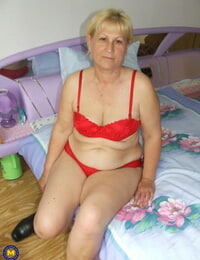 Fatty granny with saggy boobs eliminates red lingerie and poses naked in bedroom