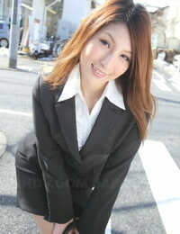 Hot redhead Japanese girl in suit poses to showcase her gorgeous face