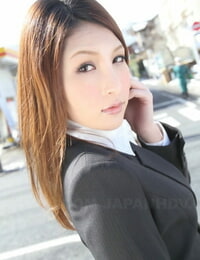 Hot redhead Japanese girl in suit poses to showcase her gorgeous face