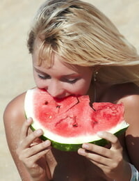 Golden-haired gf Lada poses naked and capture a watermelon on the beach