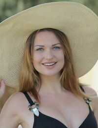 Teenage solo woman Odara liquidates a sun hat and bikini to pose nude