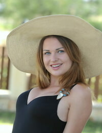 Teenage solo woman Odara liquidates a sun hat and bikini to pose nude