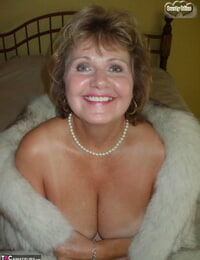 Older woman Busty Blessing munches her lips before showcasing her tits in a fur decorate