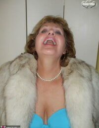 Older woman Busty Blessing munches her lips before showcasing her tits in a fur decorate