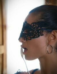 Hot female Solange sports a mask while inserting fine cutlery into her pussy