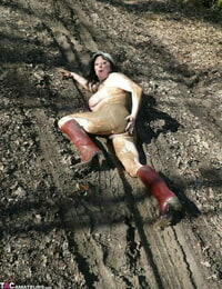 Older fledgling Mary Superslut squats for a piss in a dirt puddle while in the forest