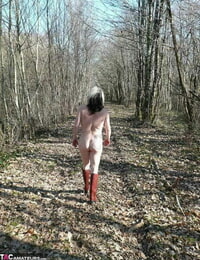 Older fledgling Mary Superslut squats for a piss in a dirt puddle while in the forest