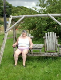 Old British lady Grandma Libby exposes her tits on a backyard bench sway