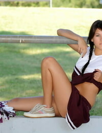 Stable chick Shyla Jennings raises up her cheerleader skirt on a lawn
