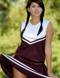 Stable chick Shyla Jennings raises up her cheerleader skirt on a lawn