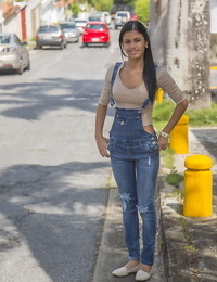 Clad dark-haired teenage Denisse Gomez displays off her pretty face in jean overalls