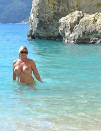 Hugely chesty mature whore Chrissy swims and lounges at the beach stark bare