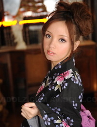 Japanese teen with a pretty face models non nude in floral print kimono