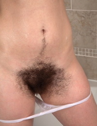 Bodacious brown-haired girl Melissa shows her hairy beaver in the bathtub