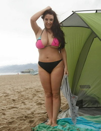 Australian babe Angela White uncovers and measures her fat knockers on the beach