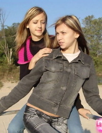 Youthfull lesbians Katrina & Laura smooch outdoors before eating bare torsos