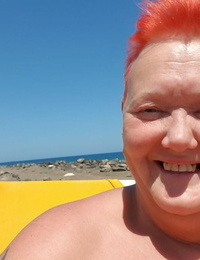 Old SSBBW Val Gasmic dyes her hair crimson before uncovering herself on the beach