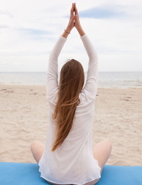 Caucasian teen Matilda Sun gets naked while doing yoga at the beach