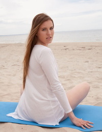 Caucasian teen Matilda Sun gets naked while doing yoga at the beach
