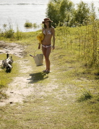Teen solo girl Elela undresses her bikini before wading into river