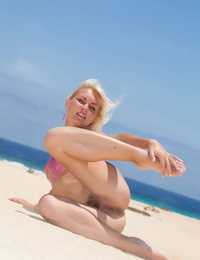 Nude ash-blonde Cristina A with small knockers displaying off wooly pussy on beach