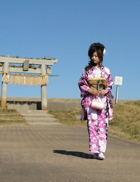 Asian model Chiaki strolls along the beach and surrounding sphere in a kimono