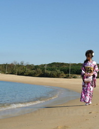 Asian model Chiaki strolls along the beach and surrounding sphere in a kimono