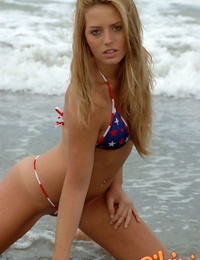 Blonde chick Shannon models in the surf wearing a bikini and a smile